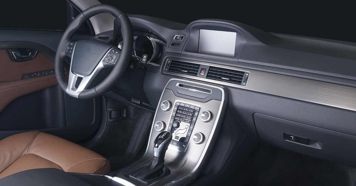 Car interior, showing steering wheel, seats and centre console.